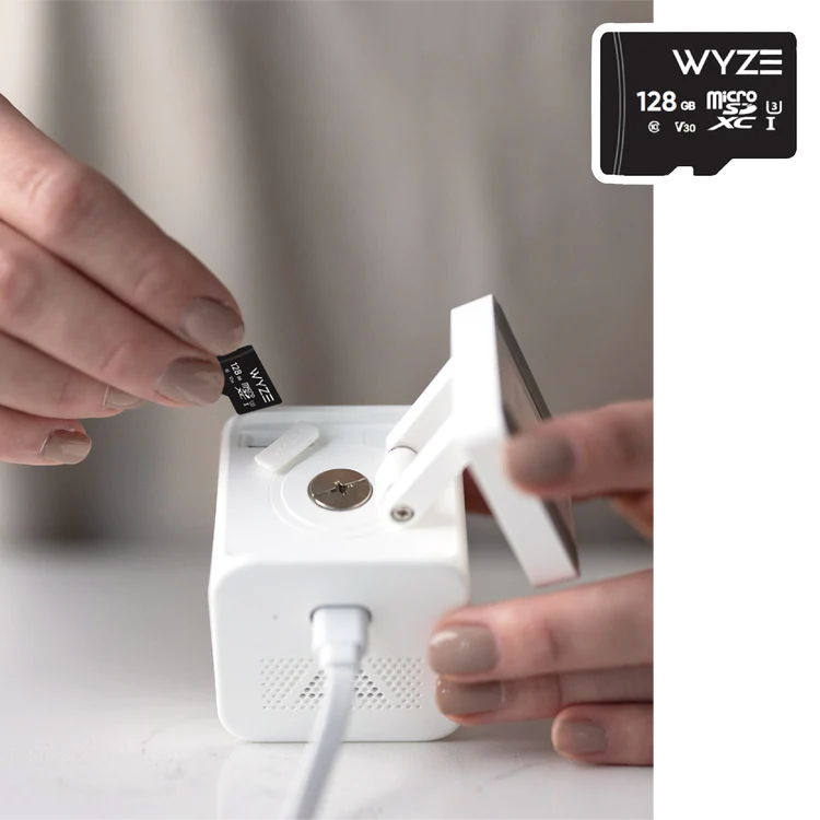 A person manually installing a MicroSD card into Wyze Cam v3