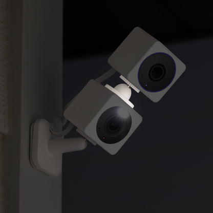 Both the Wyze Cam OG and Wyze Cam OG Telephoto connected with the stack mount and installed to a wall. Both camersa are facing the same direction.
