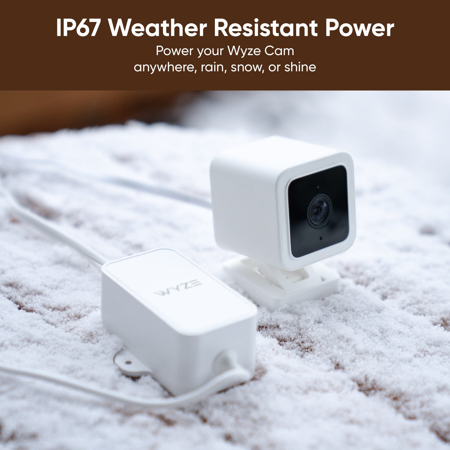 Wyze Cam v3 with an attached Wyze Outdoor Power Adapter sitting in snow. 