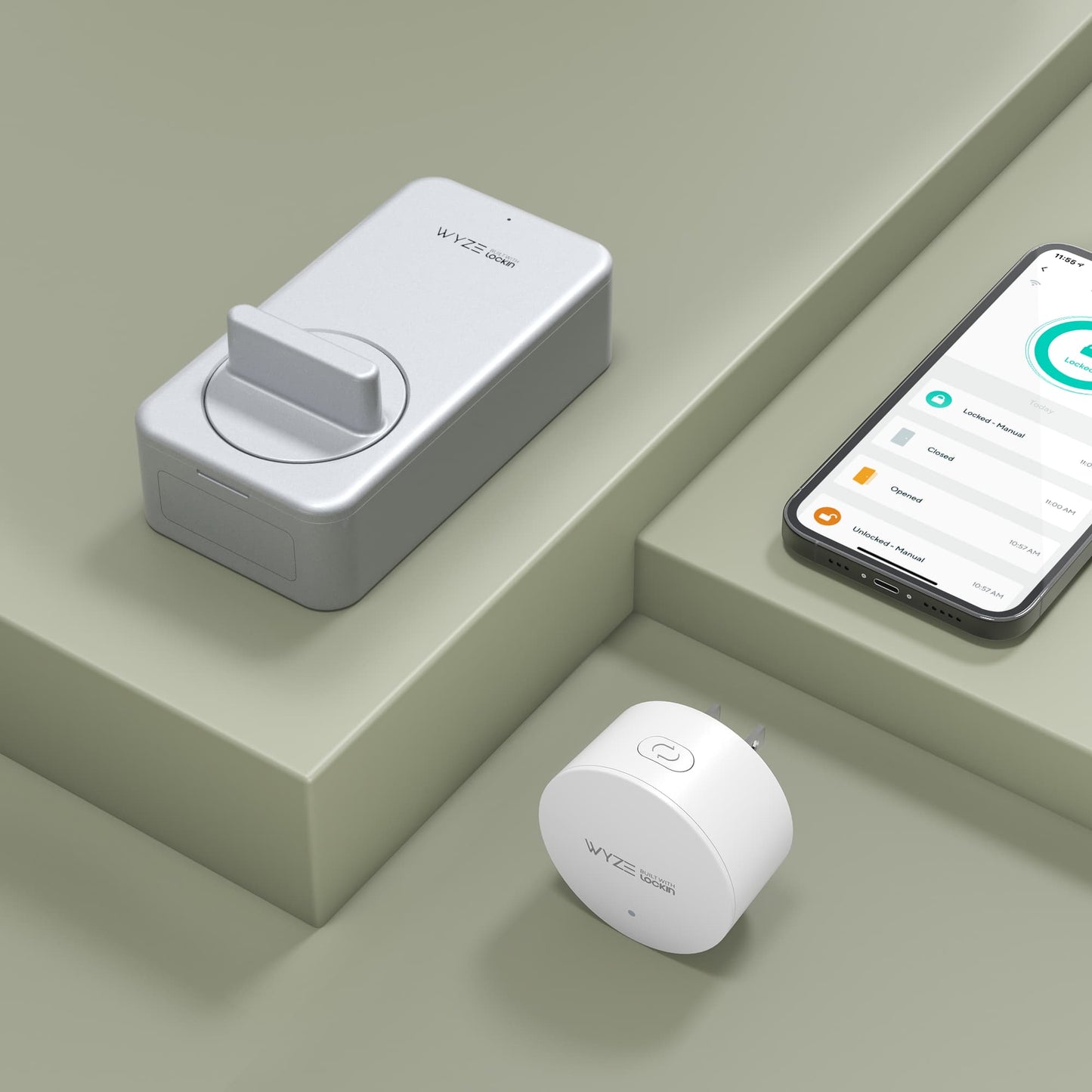 Wyze Lock product, smartphone, and gateway laid out on a gray surface.